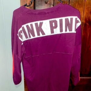 Pink Crewneck has some crack on detailing in back otherwise in good condition